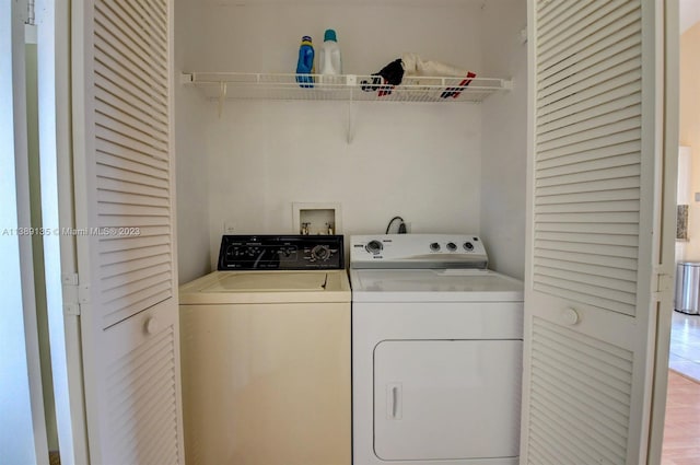 laundry room featuring hookup for a washing machine and washing machine and dryer