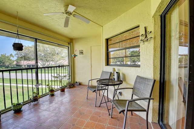 sunroom featuring ceiling fan