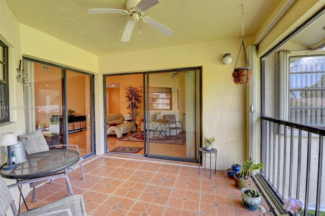 sunroom featuring ceiling fan