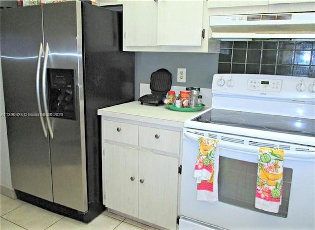 kitchen with white cabinetry, white electric range oven, light tile floors, stainless steel refrigerator with ice dispenser, and wall chimney exhaust hood