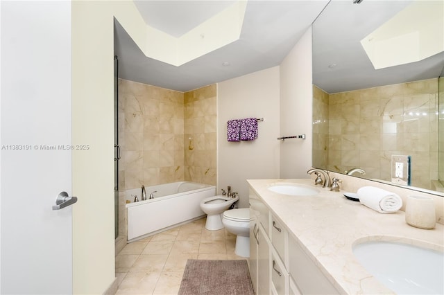 full bathroom with tile patterned flooring, vanity, toilet, a bidet, and separate shower and tub