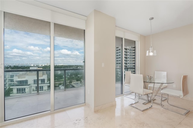 unfurnished dining area featuring plenty of natural light and floor to ceiling windows