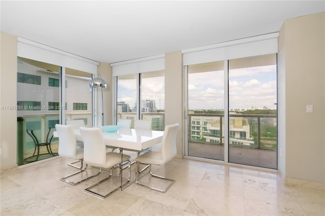 dining area featuring a wall of windows