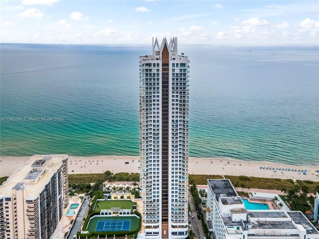 aerial view with a water view and a view of the beach