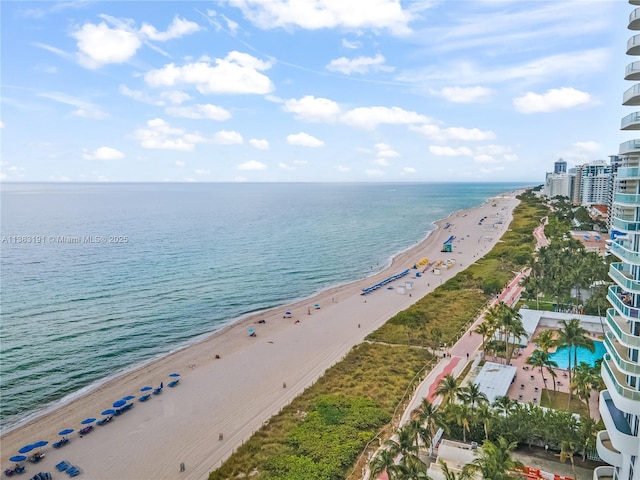 bird's eye view with a water view and a beach view