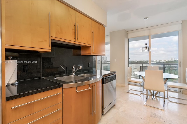 kitchen featuring decorative light fixtures, stainless steel dishwasher, backsplash, and sink