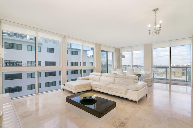6365 Collins Ave Unit 907, Miami Beach, FL 33141 - living area with a chandelier, healthy amount of natural light, floor to ceiling windows, and light tile patterned floors