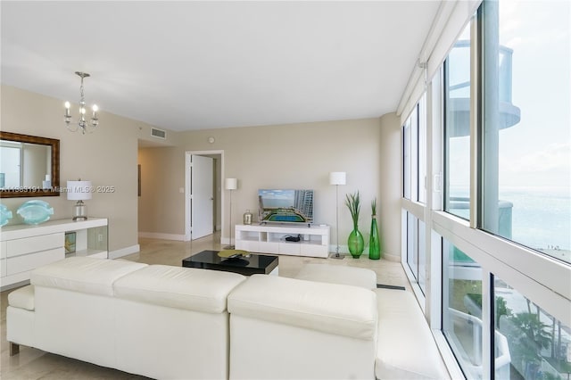 living room featuring plenty of natural light and a notable chandelier