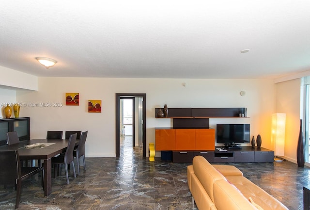 tiled living room featuring a textured ceiling