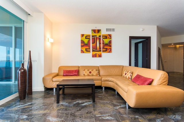 living room with dark tile floors and a textured ceiling