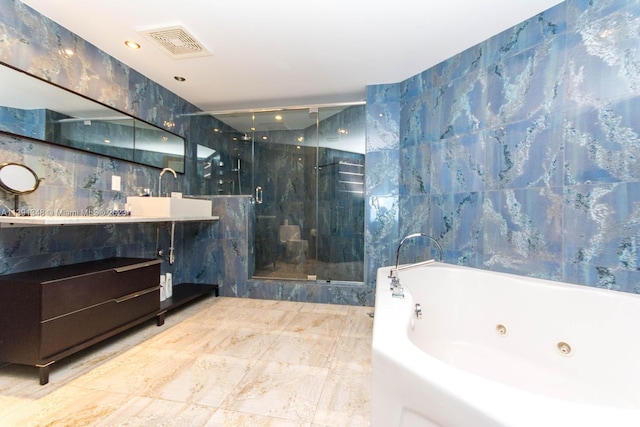 bathroom featuring shower with separate bathtub, tile walls, tile flooring, and vanity