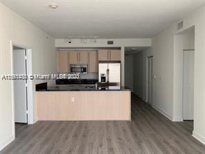 unfurnished room featuring floor to ceiling windows and dark hardwood / wood-style floors