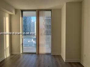 unfurnished bedroom featuring a closet and dark hardwood / wood-style flooring