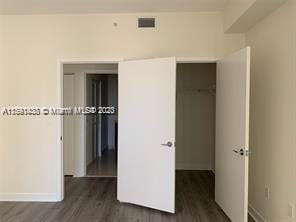 exercise room featuring hardwood / wood-style floors, a wealth of natural light, and a tray ceiling