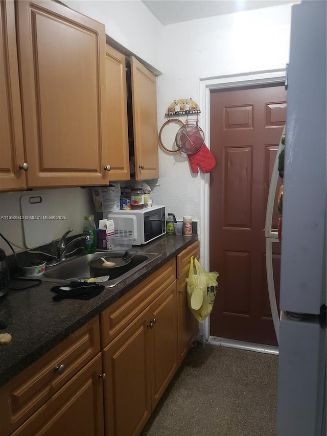 kitchen with dark stone countertops and sink