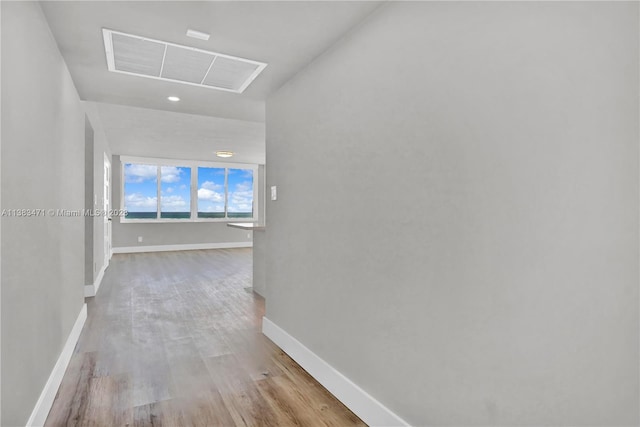 corridor with hardwood / wood-style floors