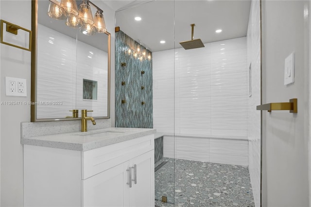 bathroom with tile walls, a shower with door, and vanity