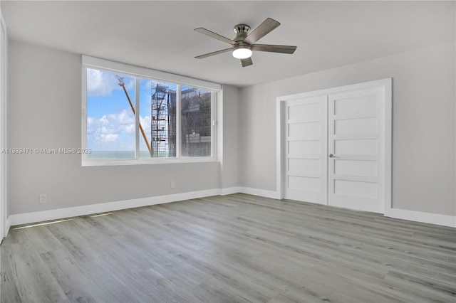 unfurnished bedroom featuring a closet, ceiling fan, and light hardwood / wood-style flooring