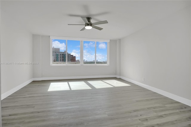 spare room with ceiling fan and light hardwood / wood-style flooring