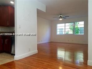 spare room featuring ceiling fan and hardwood / wood-style floors