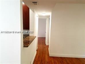 hallway featuring dark wood-type flooring