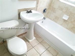 bathroom with tile patterned flooring and toilet