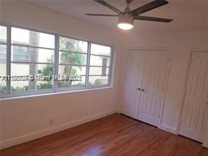 unfurnished bedroom featuring wood-type flooring and ceiling fan