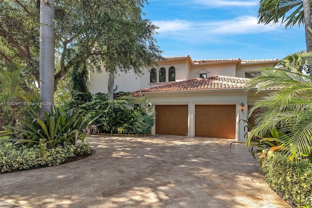 mediterranean / spanish house with a garage