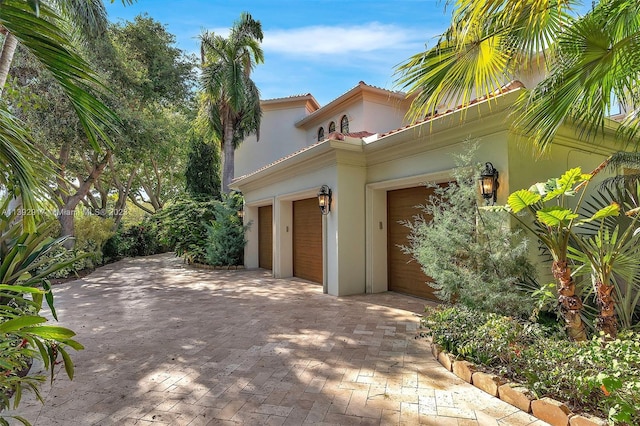 mediterranean / spanish house featuring a garage