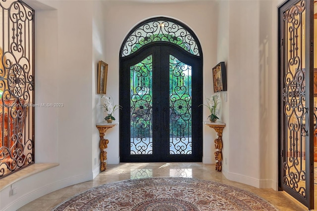 tiled entryway featuring french doors