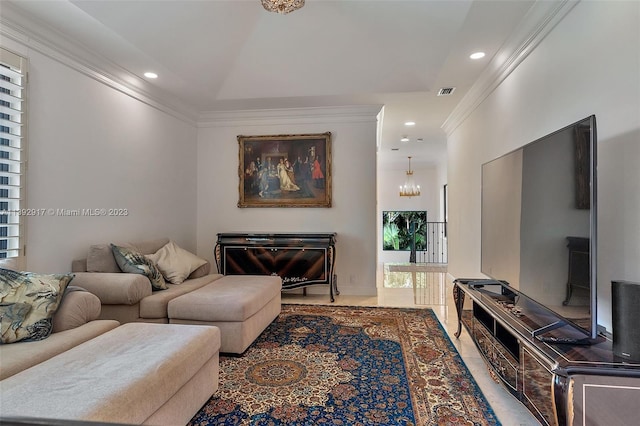 living room with ornamental molding and a chandelier