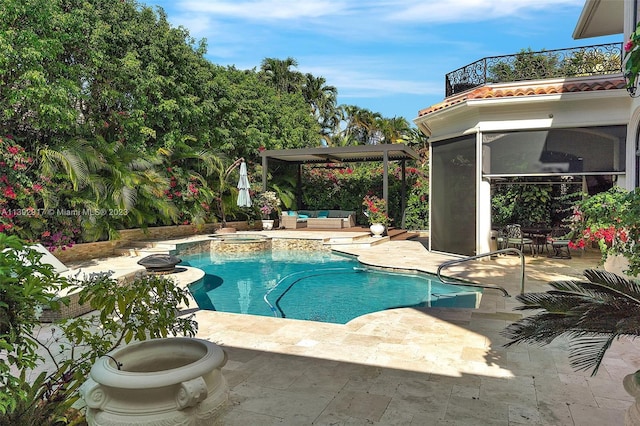 view of swimming pool featuring a patio area and an in ground hot tub