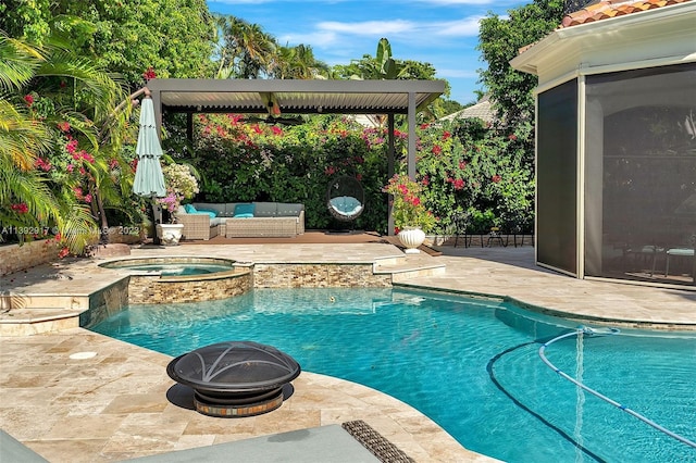 view of pool with an in ground hot tub, an outdoor living space with a fire pit, and a patio