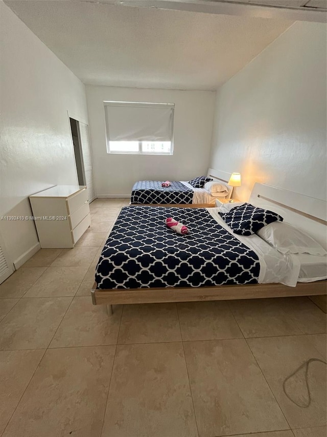 bedroom featuring light tile floors