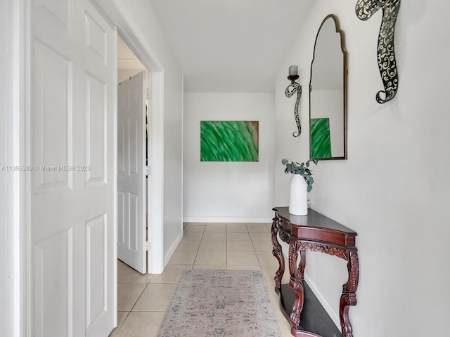 hall featuring light tile floors