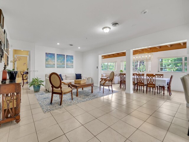 living room featuring a notable chandelier and light tile floors