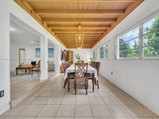 tiled dining space featuring wood ceiling, beamed ceiling, and a notable chandelier