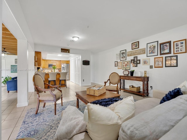 living room featuring ceiling fan and light tile floors