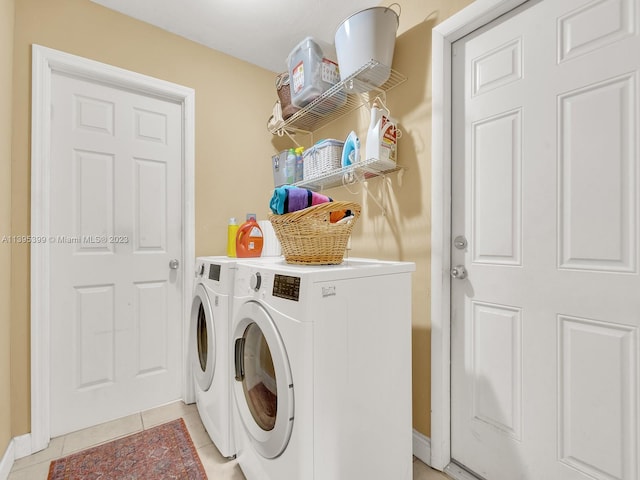 laundry room featuring light tile floors and washer and dryer