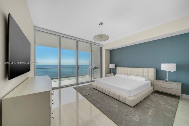 bedroom with expansive windows, access to exterior, light tile flooring, and a water view