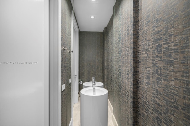 bathroom featuring tile floors and tile walls