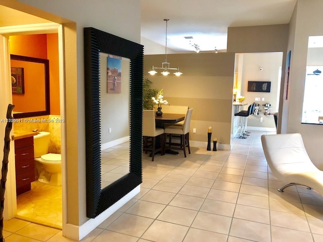 interior space with a notable chandelier and light tile floors