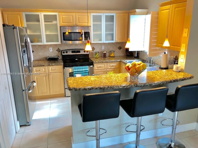 kitchen featuring light tile floors, backsplash, and stainless steel appliances