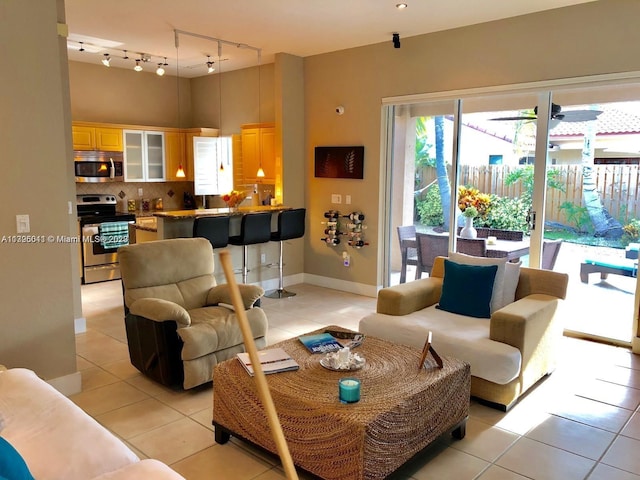 living room featuring light tile flooring and track lighting