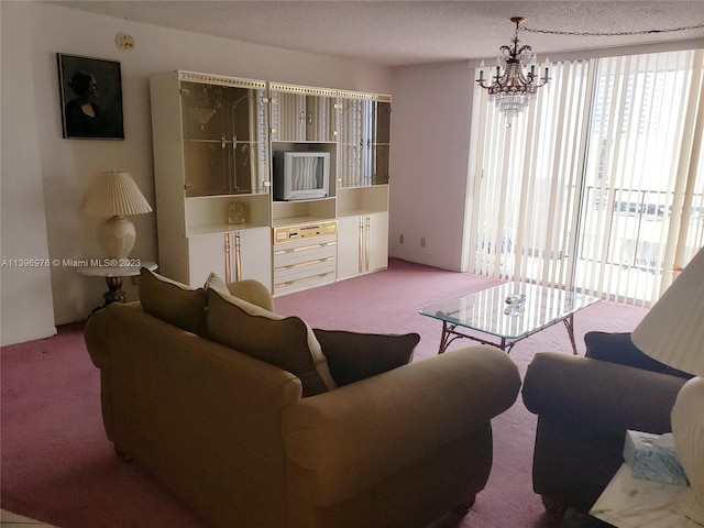 carpeted living room with a notable chandelier and a textured ceiling