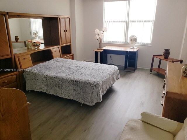 bedroom with dark wood-type flooring