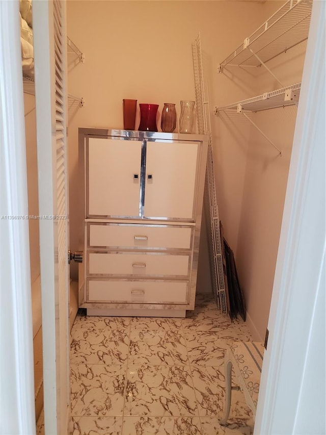 spacious closet featuring light tile floors