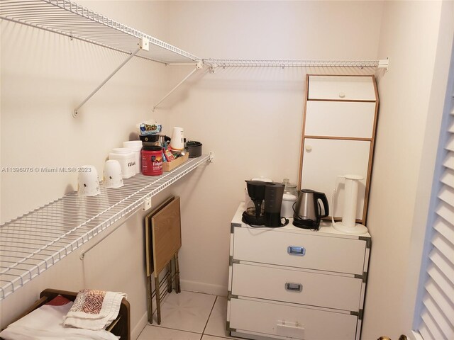 walk in closet featuring light tile floors