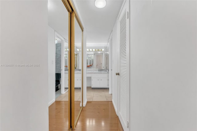 corridor with light wood-style flooring