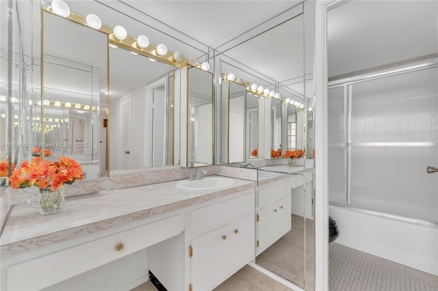 bathroom with enclosed tub / shower combo, vanity, and tile patterned floors